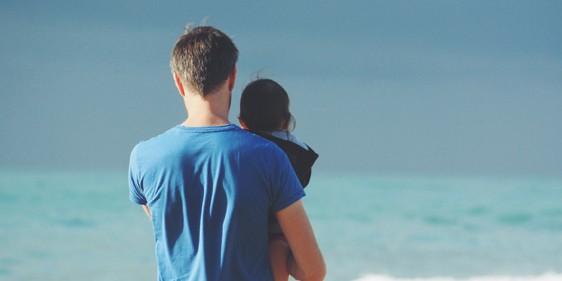 father and child at beach